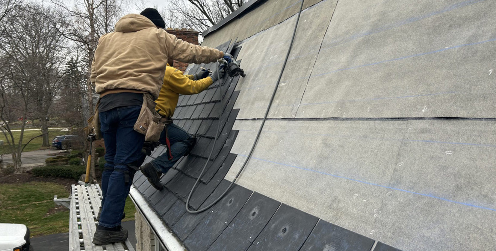 Roofing team completing project